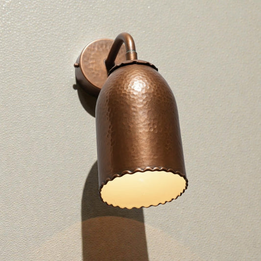 Copper wall light fixture on a neutral background