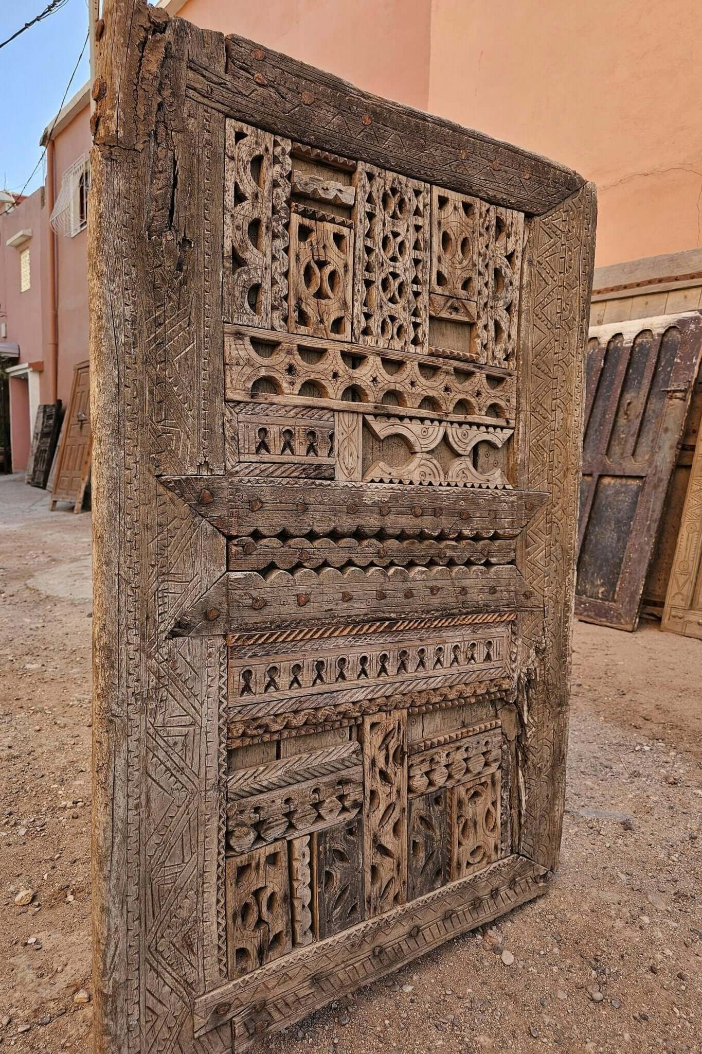 Handcrafted antique Moroccan door with floral hand-carving in natural wood