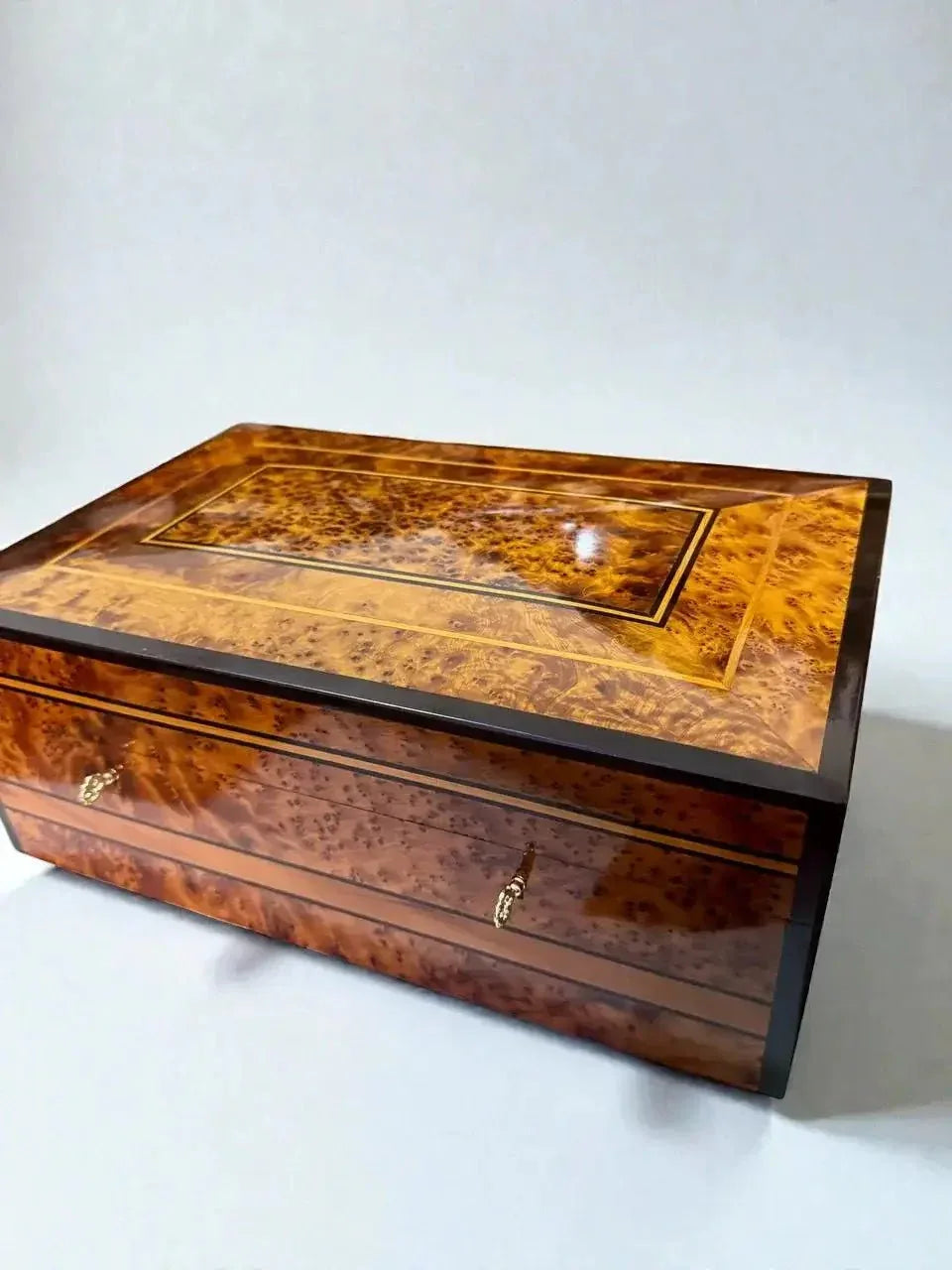 Side view of artisan Thuya wood jewelry box with polished burl grain