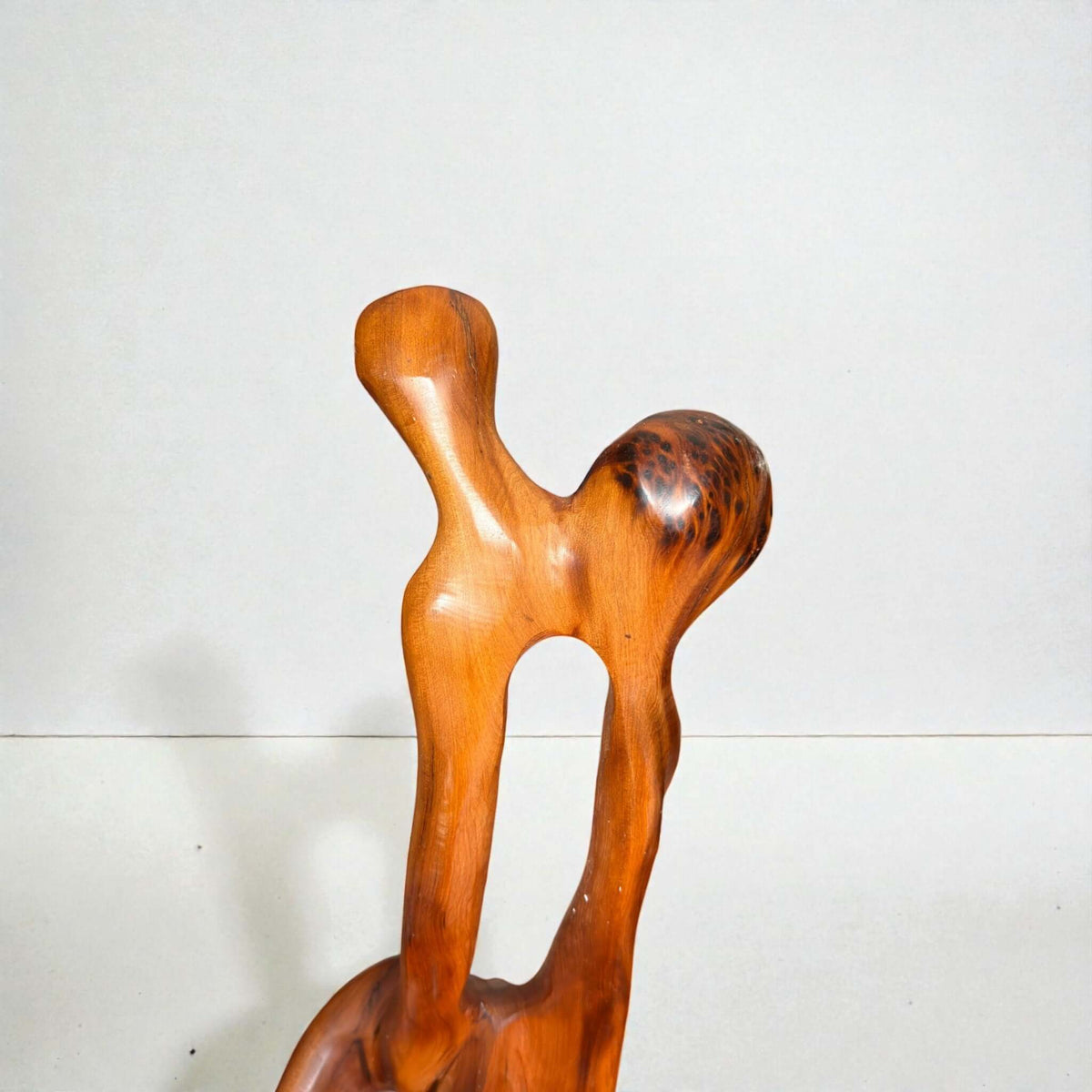 Thuya wood sculpture with natural grain and organic carved form