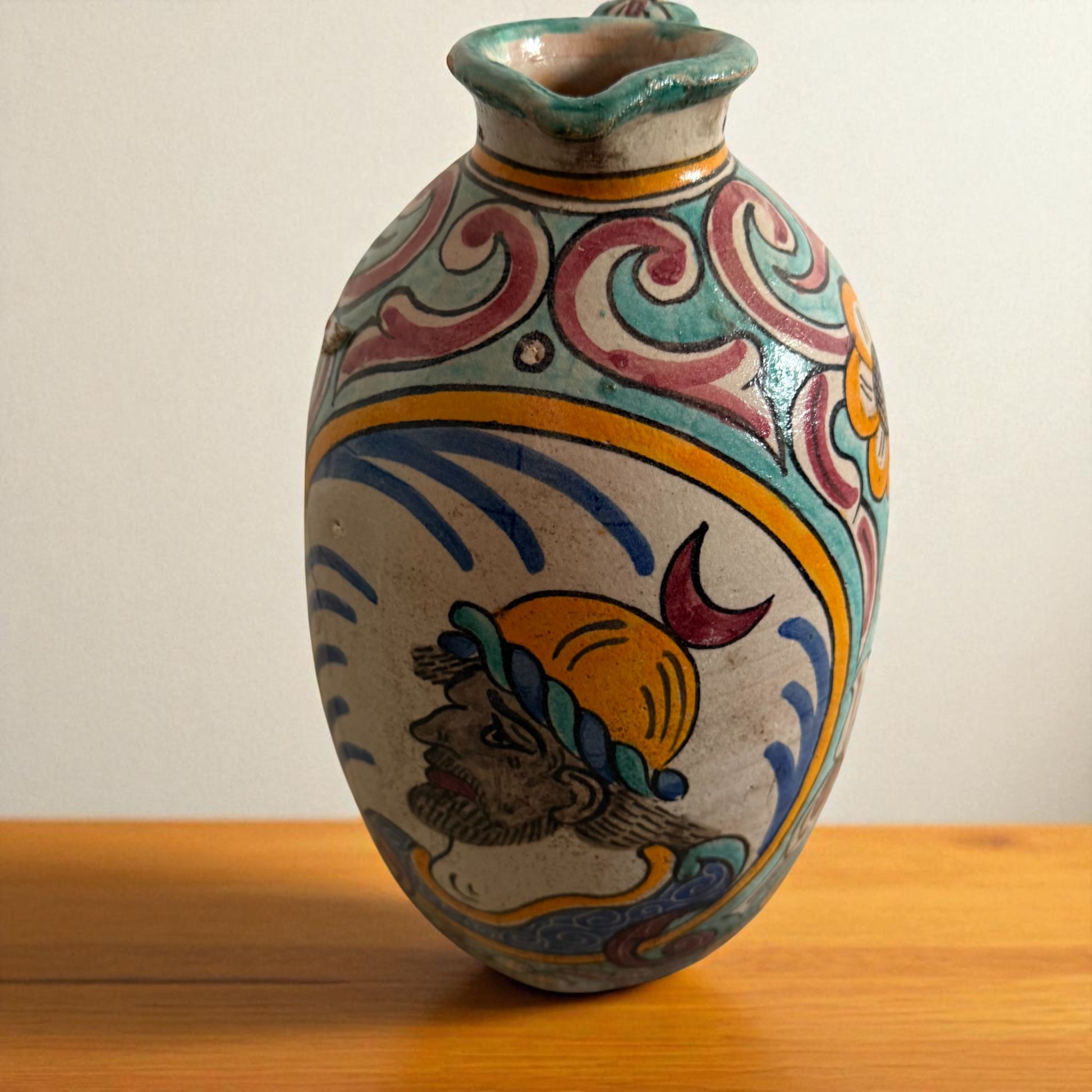 Decorated ceramic pitcher with human figure.