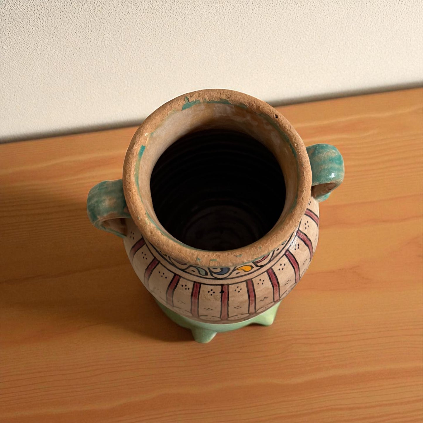 Earthenware vase with handles and decorative painting.