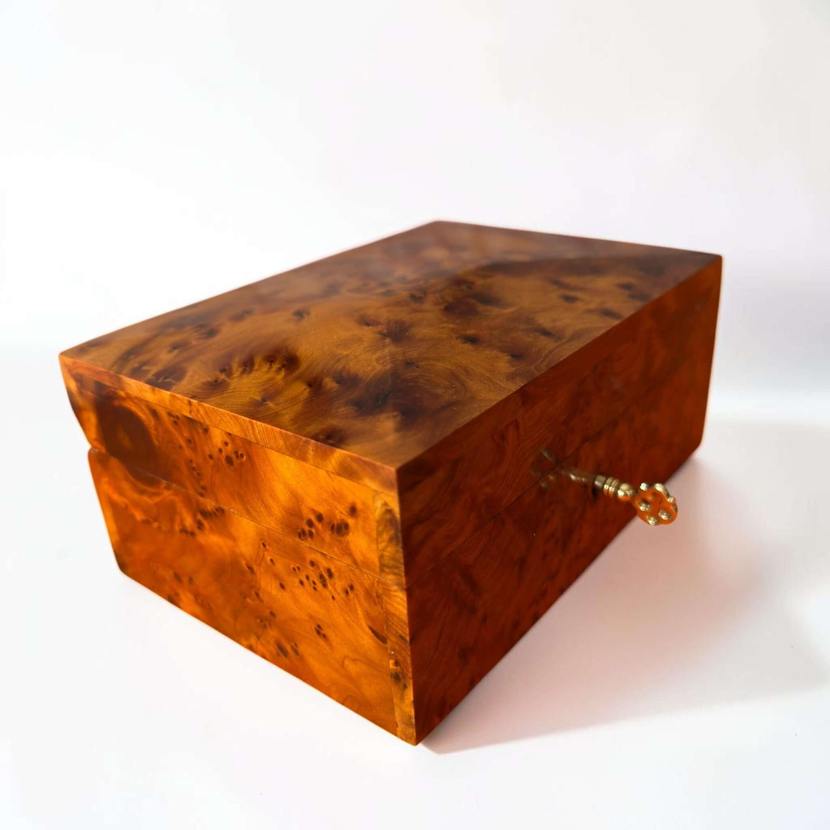 Handmade Thuya Burl Wood Jewelry Box with unique patterns and lockable design, showcasing intricate Moroccan craftsmanship.