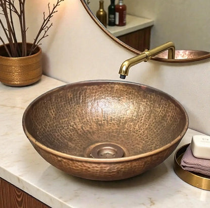 Beautiful hammered copper vessel sink displayed in an elegant bathroom setting with modern faucet.