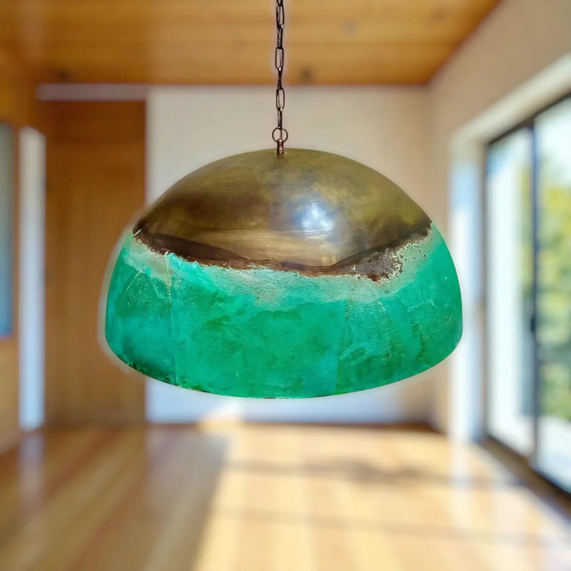 Copper Dome Pendant Light showcasing a unique green and bronze design in a modern interior setting.