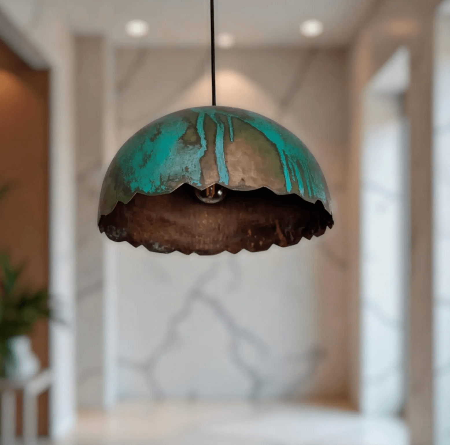 Green Patina Scalloped Copper Dome Pendant Light hanging in an elegant interior.