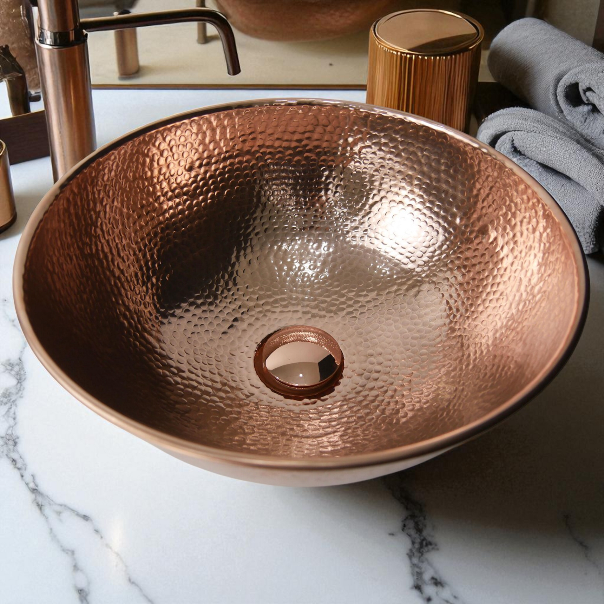 Copper hammered sink on marble countertop.