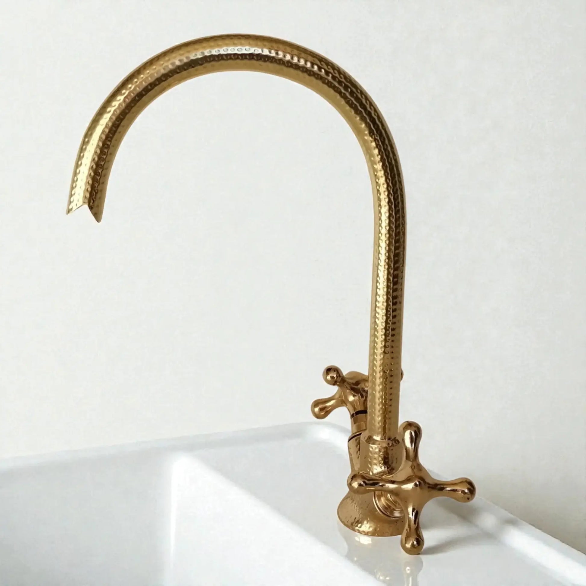 Gold kitchen faucet on a white background