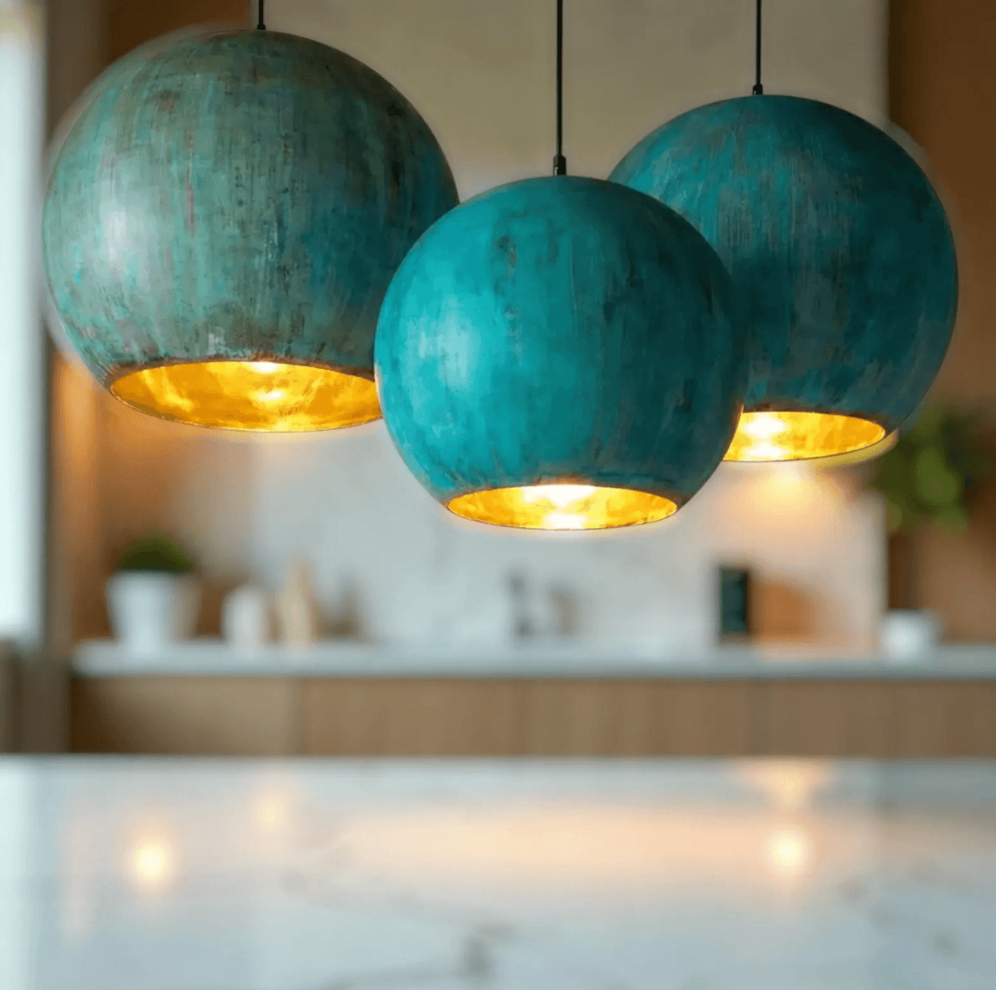 Green Patina Copper Pendant Light showcasing three textured globe designs with warm golden interiors.