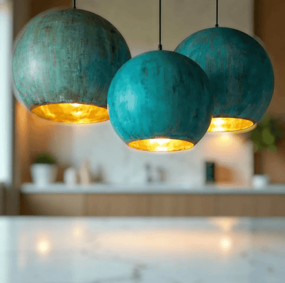 Green Patina Copper Pendant Light showcasing three textured globe designs with warm golden interiors.