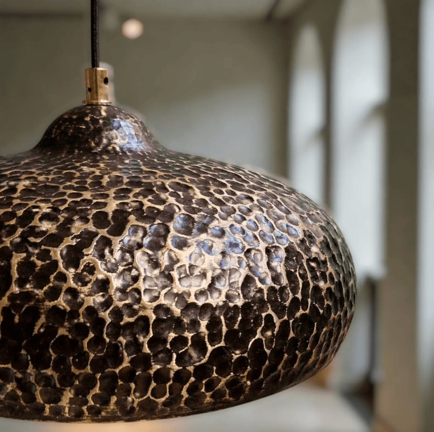 Hammered Dark Patina Copper UFO Pendant Light showcasing its unique textured design and warm tones.