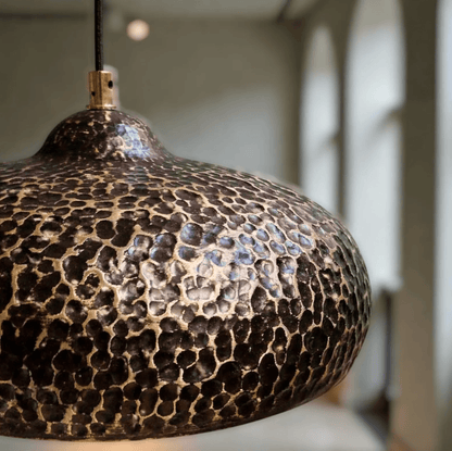 Hammered Dark Patina Copper UFO Pendant Light showcasing its unique textured design and warm tones.