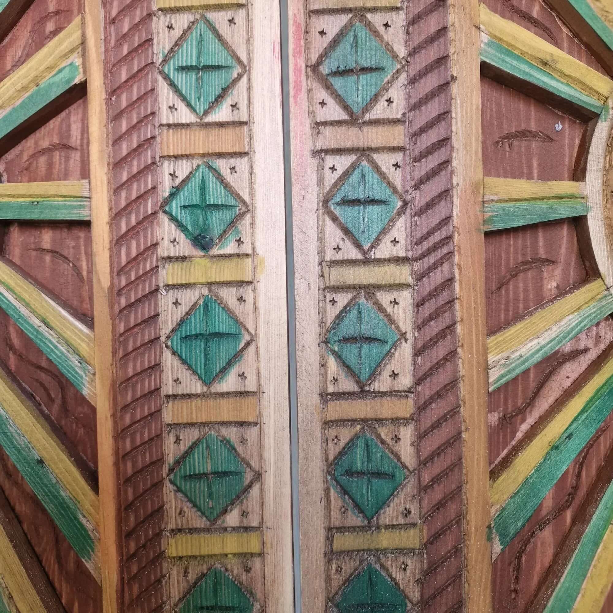 Hand-painted natural wood door — vibrant pigment detail