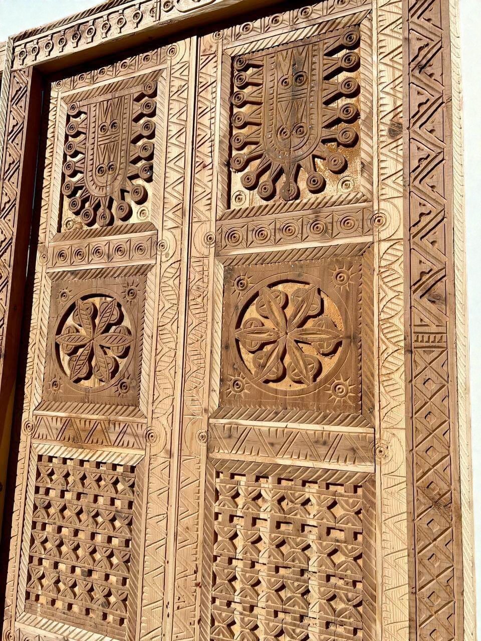 AtlasMuseCrafts antique double wood door with intricate Moorish hand-carving and geometric patterns.