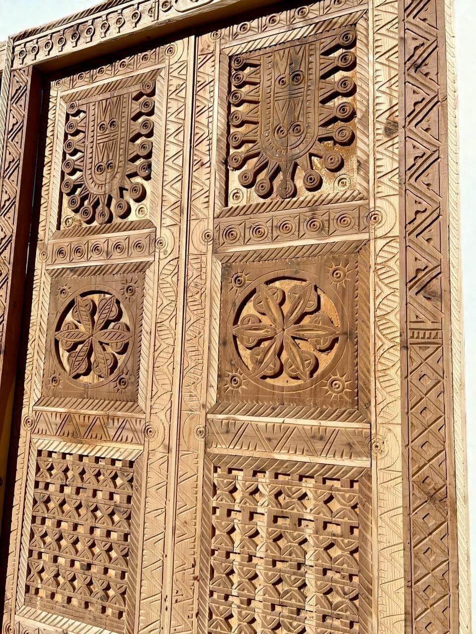 AtlasMuseCrafts antique double wood door with intricate Moorish hand-carving and geometric patterns.