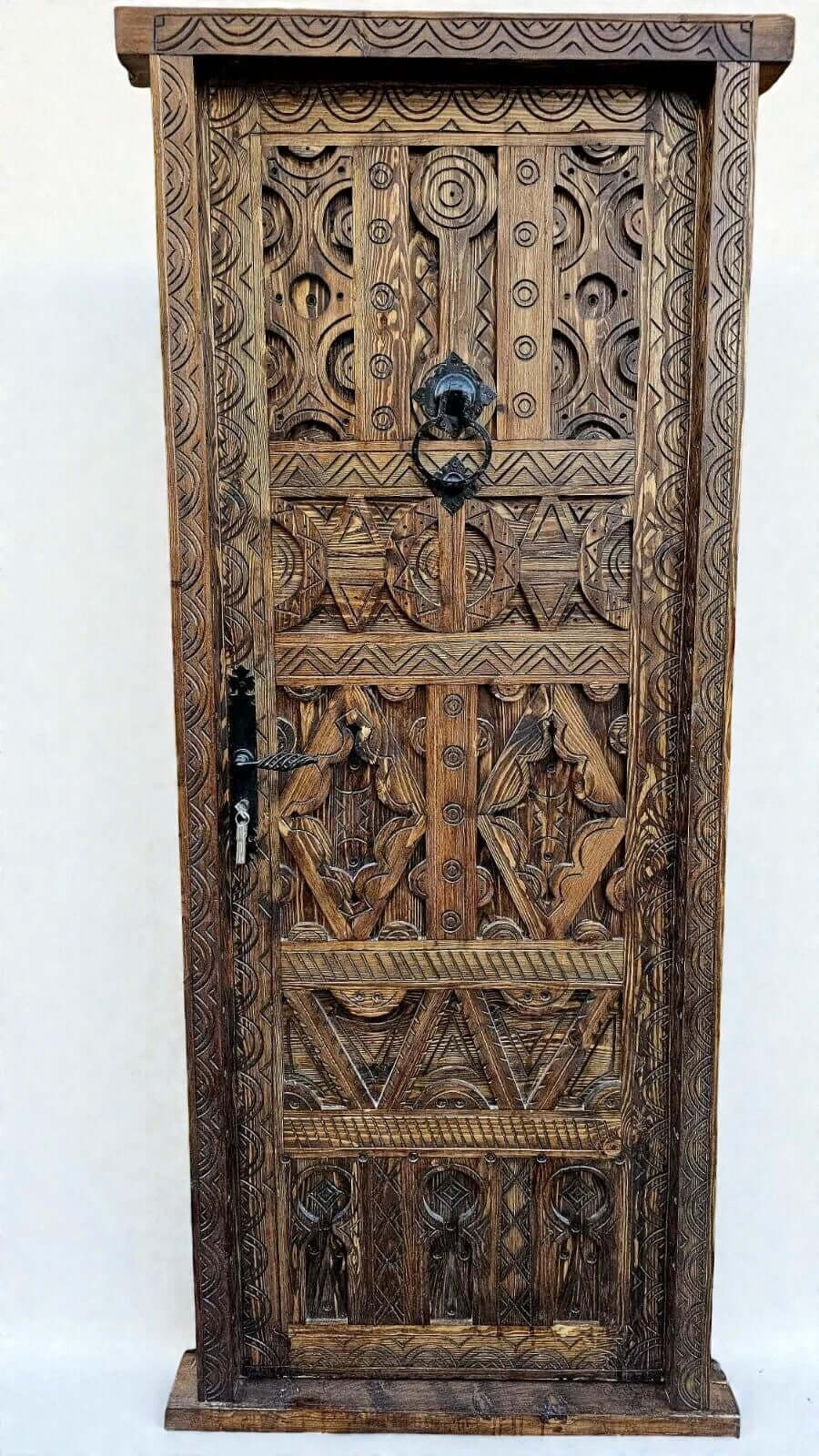 AtlasMuseCrafts antique Moroccan door made of natural wood with intricate Berber carving and black metal hardware.
