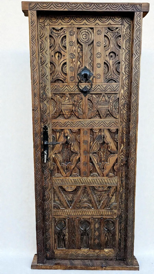 AtlasMuseCrafts antique Moroccan door made of natural wood with intricate Berber carving and black metal hardware.
