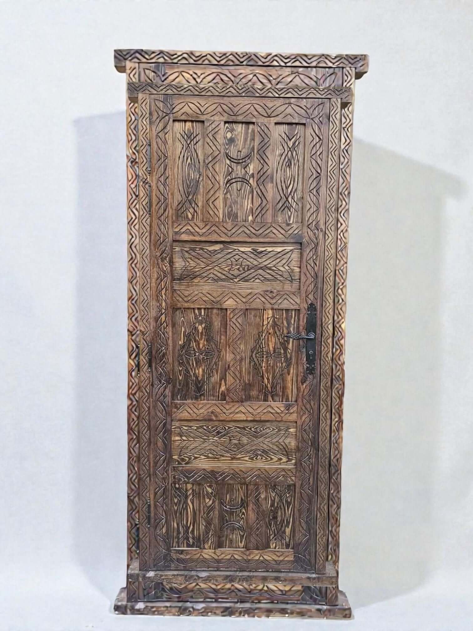 AtlasMuseCrafts antique Moroccan door made of natural wood with intricate Berber carving and a dark metal handle.