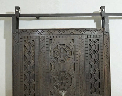 AtlasMuseCrafts dark wood sliding barn door with intricate traditional floral carving and geometric patterns.