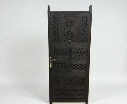 AtlasMuseCrafts dark wood door with intricate floral and geometric carvings, featuring a ring pull and ornate handle.