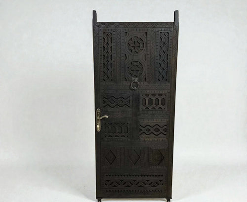 AtlasMuseCrafts dark wood door with intricate floral and geometric carvings, featuring a ring pull and ornate handle.