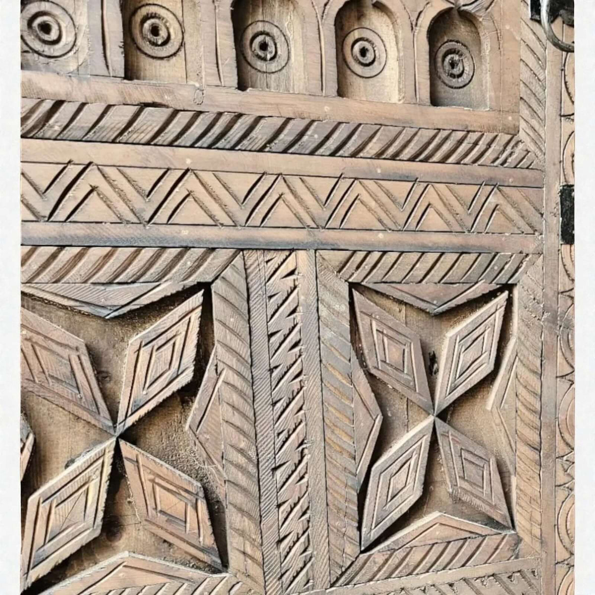 AtlasMuseCrafts handcrafted wooden cabinet with intricate Berber carvings and geometric patterns. Rustic boho style.