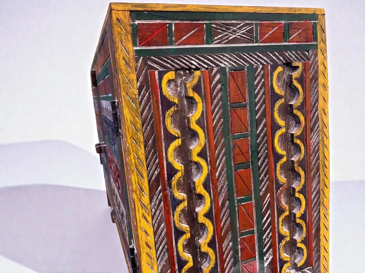 AtlasMuseCrafts handmade wooden cabinet with intricate Berber carvings in yellow, red, green, and brown. Rustic boho style.