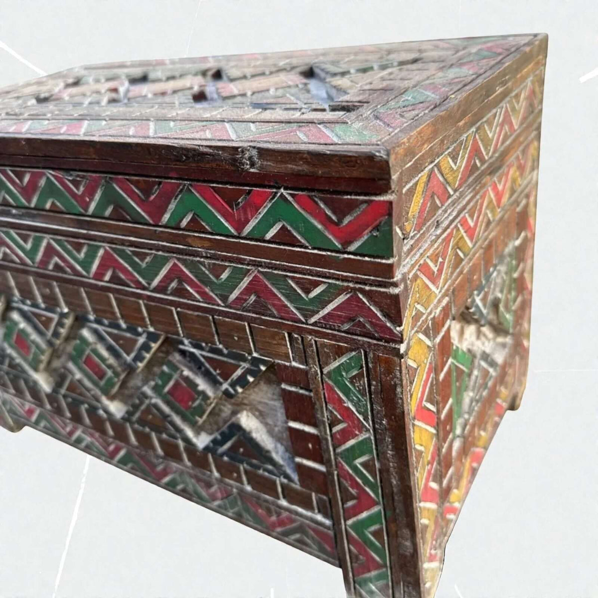 AtlasMuseCrafts handmade wooden cabinet with intricate Berber carvings in red, green, and yellow. Rustic boho style storage.