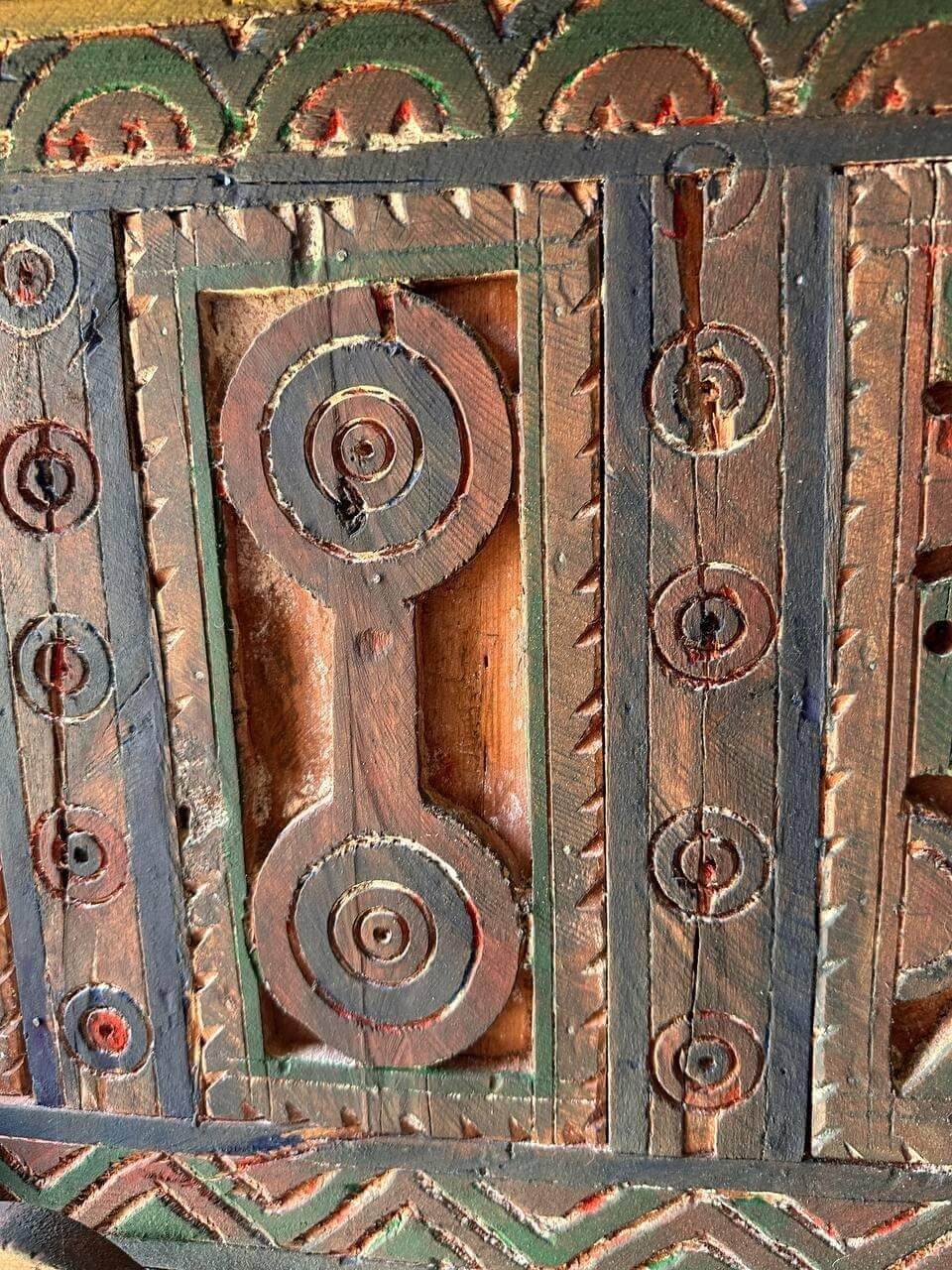 AtlasMuseCrafts handmade wooden door with brass knobs, featuring intricate Moroccan geometric carvings and natural wood finish.
