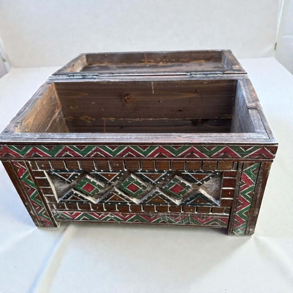 AtlasMuseCrafts handmade wooden storage chest with carved Berber patterns in red, green, and white. Rustic boho style.
