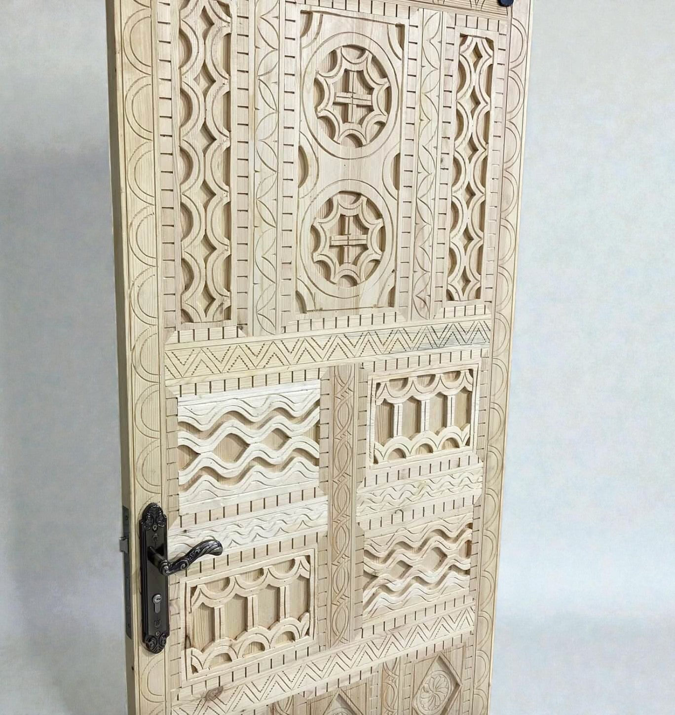 AtlasMuseCrafts vintage Moroccan carved wood door with intricate geometric and arabesque patterns. Natural wood finish.