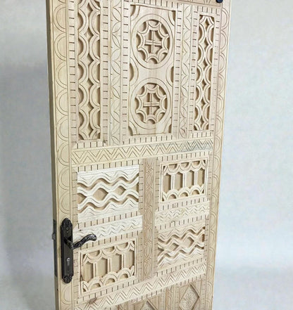 AtlasMuseCrafts vintage Moroccan carved wood door with intricate geometric and arabesque patterns. Natural wood finish.