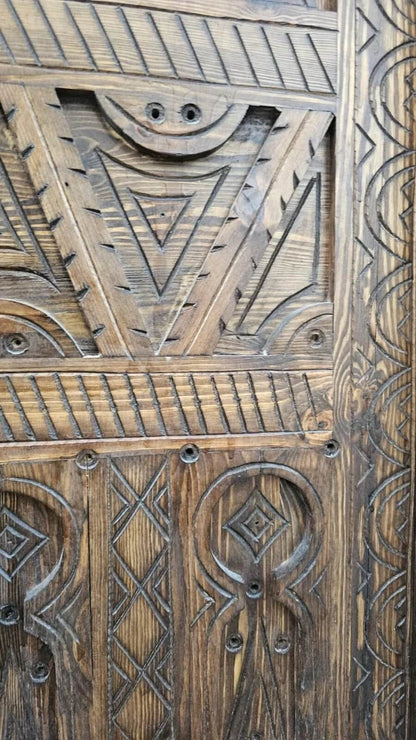 AtlasMuseCrafts antique Moroccan door, natural wood with intricate Berber carving. Features geometric patterns and a rustic finish.