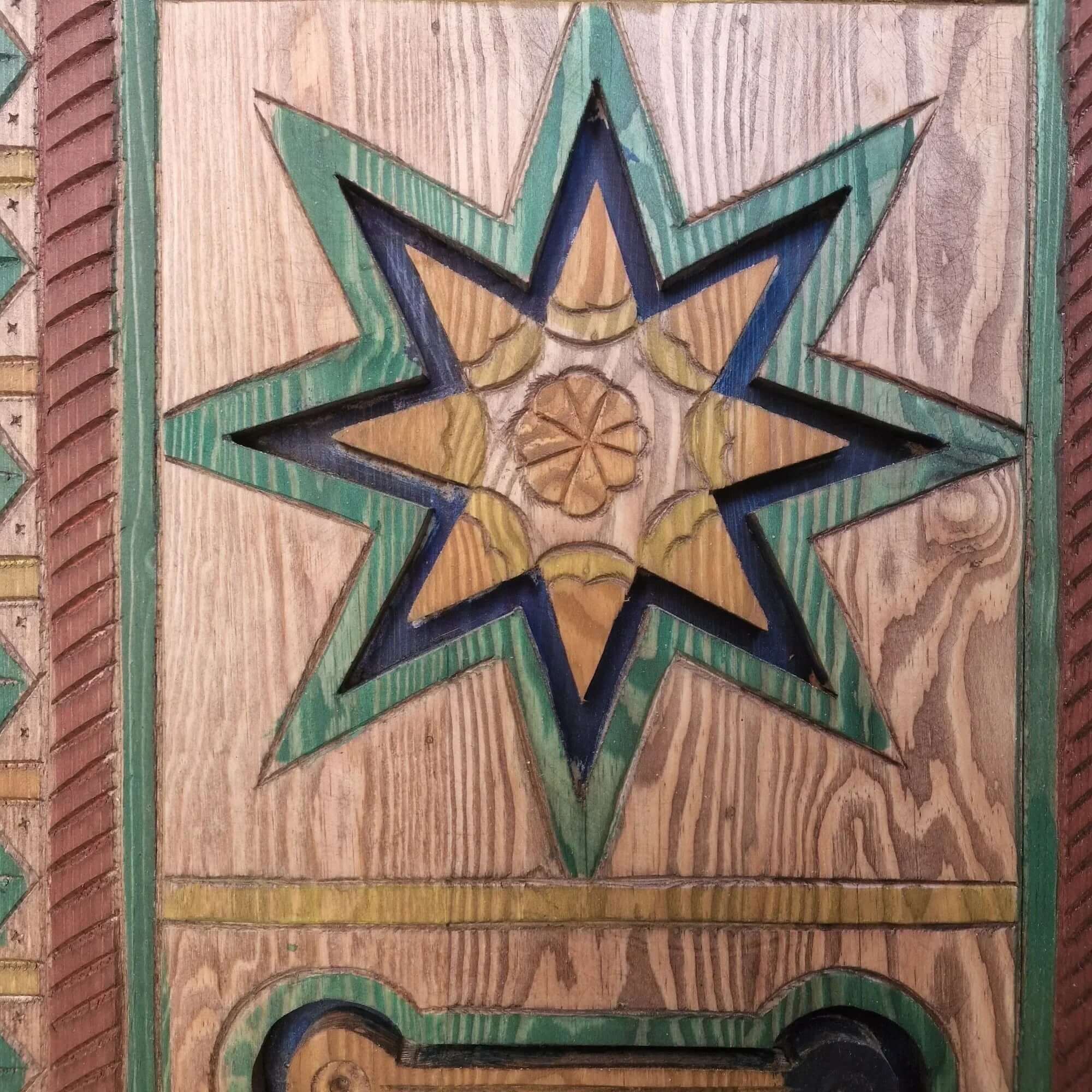 AtlasMuseCrafts hand-painted multicolor Moroccan door with geometric carving in wood. Features a star motif with green, blue, and yellow accents.