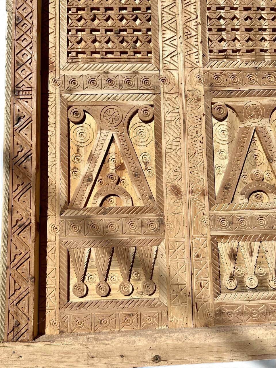 AtlasMuseCrafts antique Moroccan double door made of natural wood with intricate Moorish hand-carving and geometric patterns.