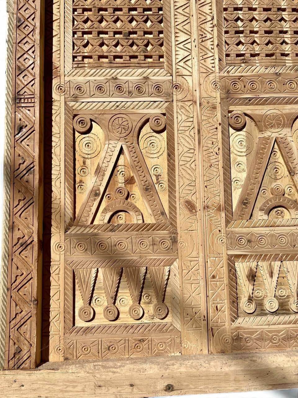 AtlasMuseCrafts antique Moroccan double door made of natural wood with intricate Moorish hand-carving and geometric patterns.