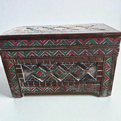 AtlasMuseCrafts custom Moroccan wood cabinet with hand-carved Berber patterns in red, green, and white.