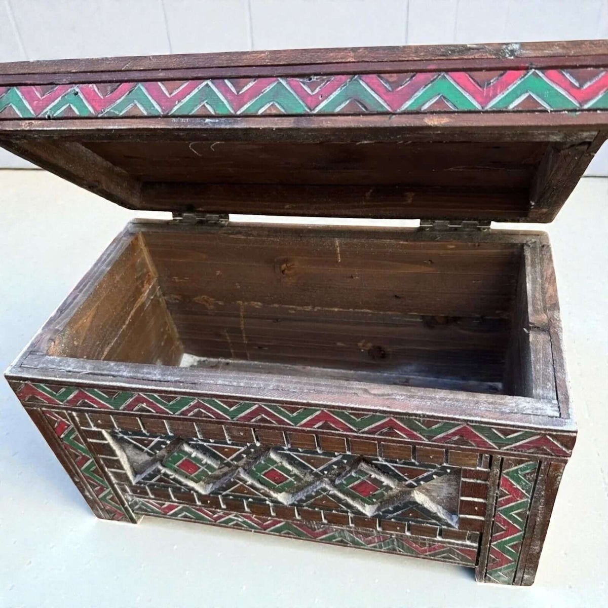 AtlasMuseCrafts custom Moroccan wood cabinet with hand-carved Berber patterns in red and green. Rustic boho storage chest.