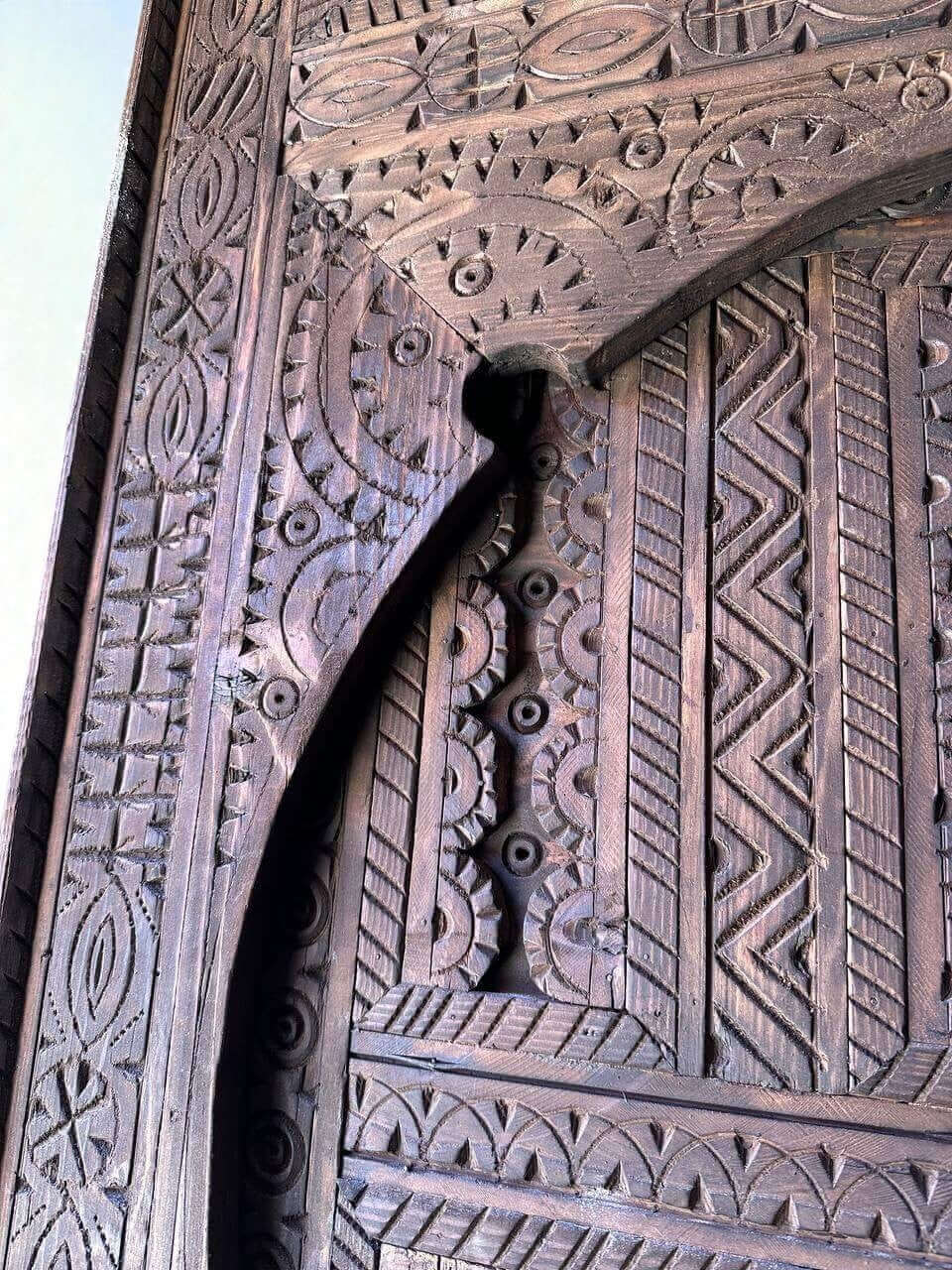 AtlasMuseCrafts dark wood Moroccan door with intricate geometric hand-carving. Custom made.