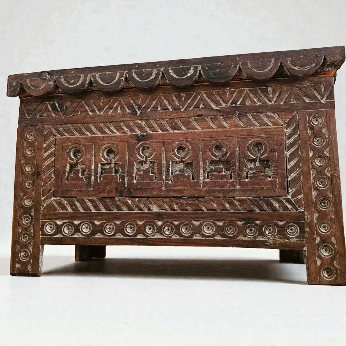 AtlasMuseCrafts Moroccan wooden cabinet with intricate hand-carved Berber patterns and scalloped top edge.