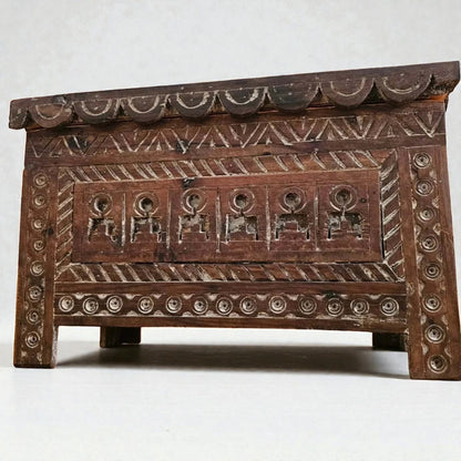 AtlasMuseCrafts Moroccan wooden cabinet with intricate hand-carved Berber patterns and scalloped top edge.