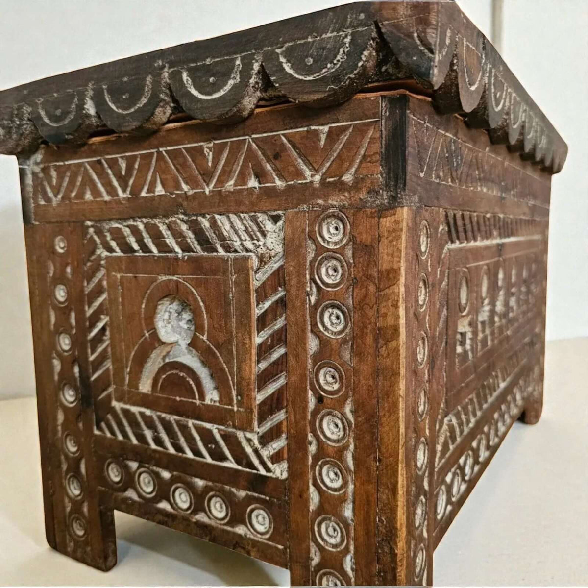 AtlasMuseCrafts Moroccan wooden cabinet with intricate hand-carved Berber patterns and scalloped detailing.