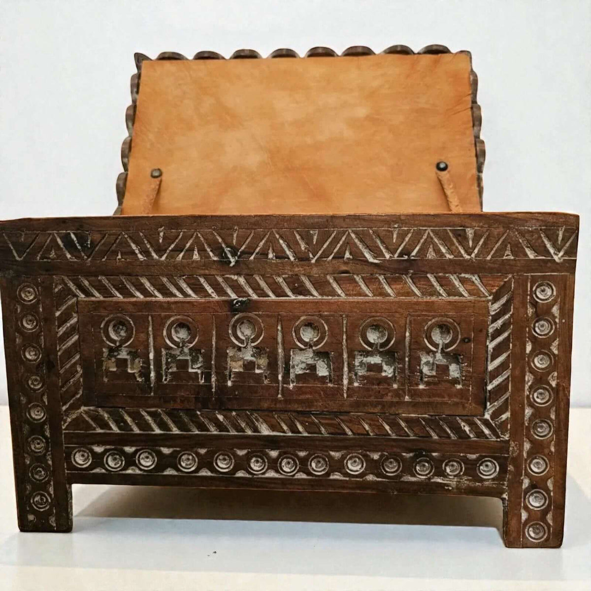 AtlasMuseCrafts Moroccan wooden cabinet with intricate hand-carved Berber patterns and a tan leather-lined interior.