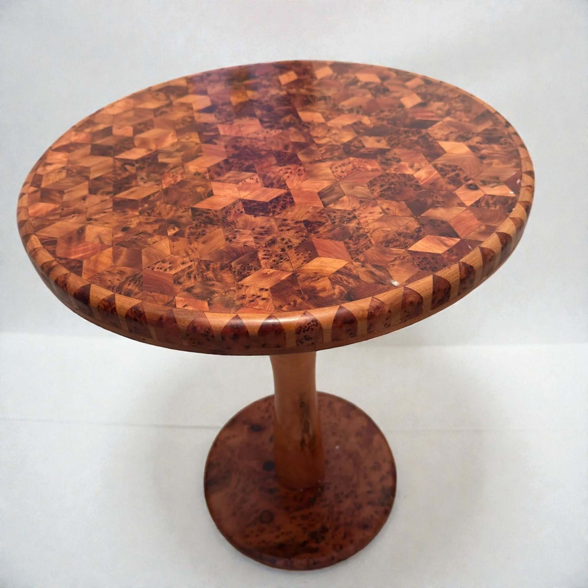 Round coffee table with solid wood mosaic top and pedestal base