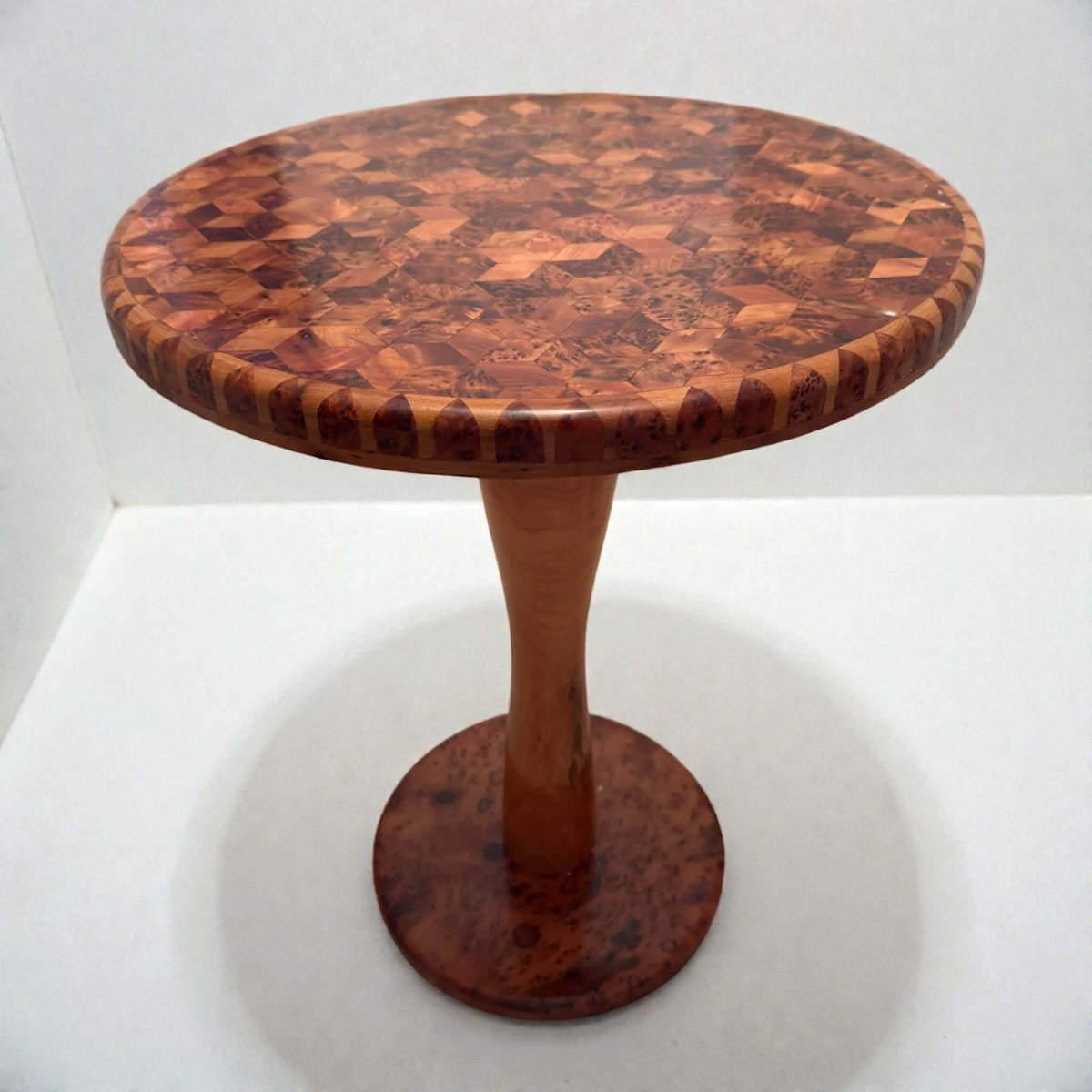 Round solid wood coffee table with mosaic top and pedestal base