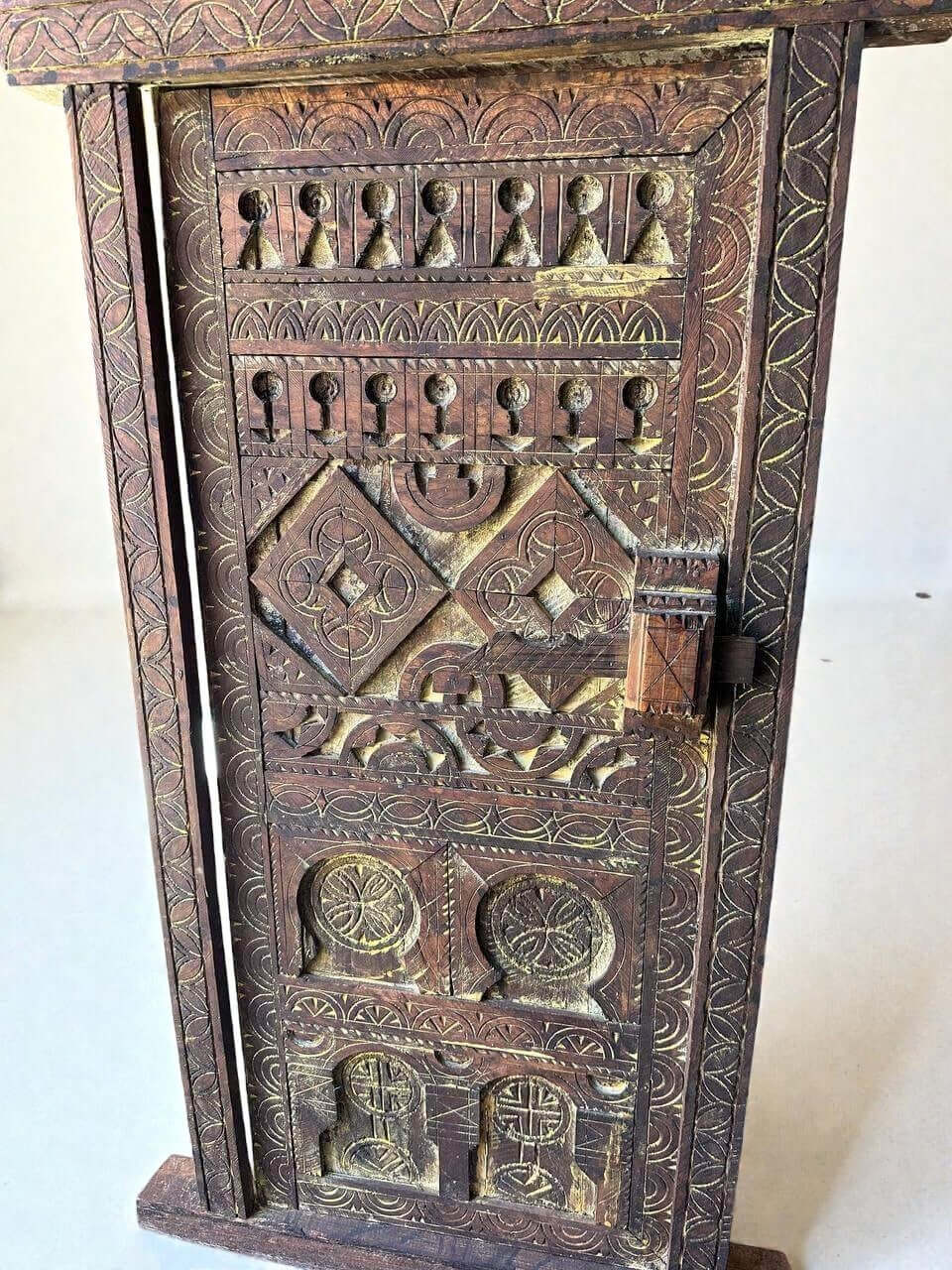 AtlasMuseCrafts vintage wooden door with brass knob, featuring intricate floral carvings and a distressed finish.