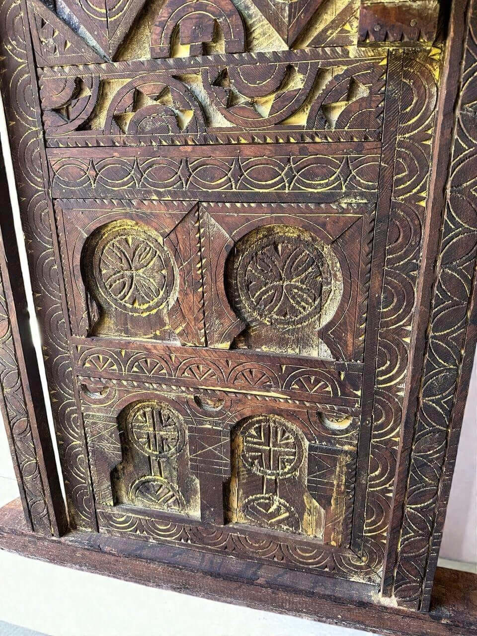 AtlasMuseCrafts vintage wooden door with intricate floral carvings and an antique brass knob. Natural wood finish.