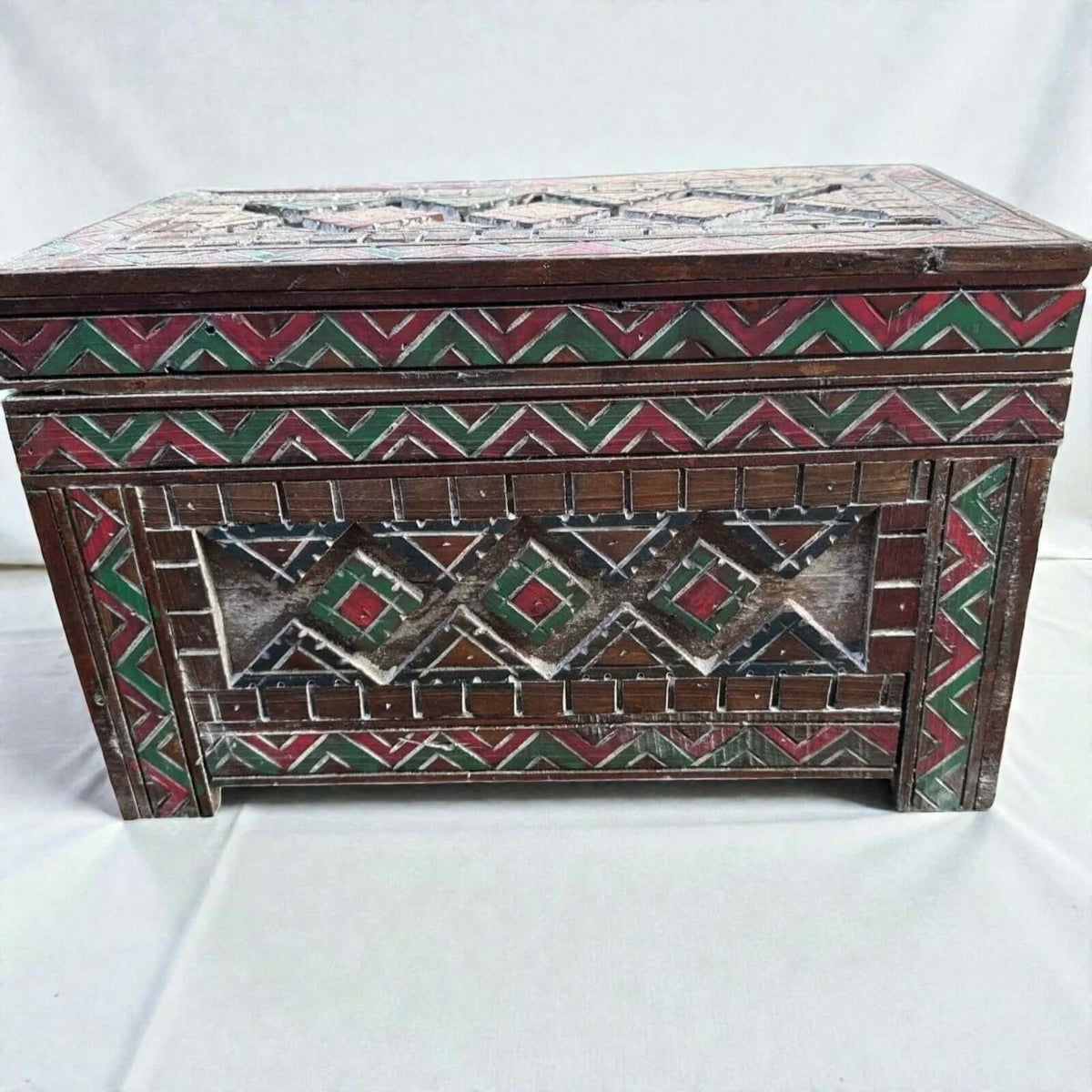 AtlasMuseCrafts handmade wooden storage cabinet with carved Berber patterns in red, green, and white. Rustic boho style.