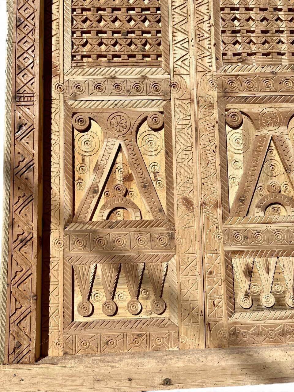 AtlasMuseCrafts antique double wooden door with intricate Moorish hand-carving and geometric patterns.