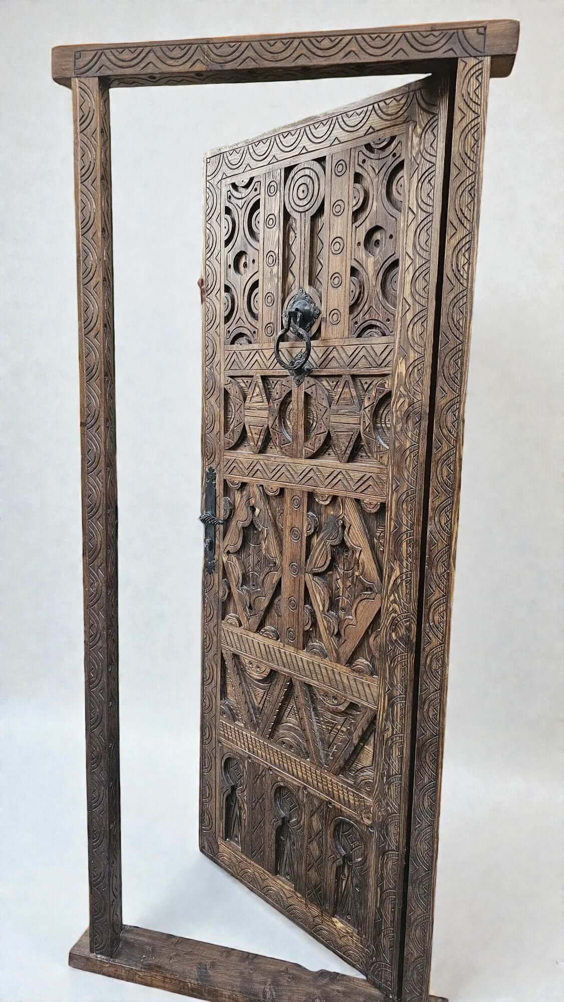 AtlasMuseCrafts antique Moroccan door, natural wood with intricate Berber carving and lion head knocker.